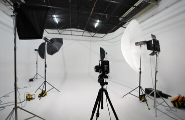An empty photo Studio with white cyclorama. Monoblocks with flashes using softboxes of different...