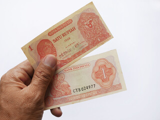 human hand holding  collection of old indonesia rupiah banknotes.