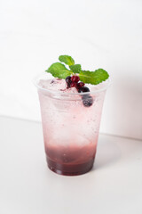 mix berry with soda in glass