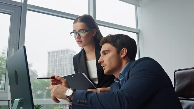 Two managers discussing digital marketing report. Focused assistant taking notes