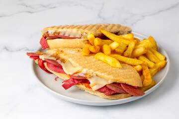 Delicious looking hot sandwich - toast. Sandwich with mixed toast, cheddar cheese and salami.