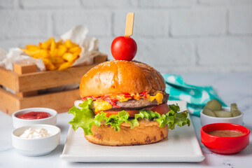 Homemade hamburger served with french fries.