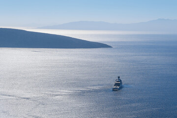 Yacht sails on the sea against the backdrop of the mountains