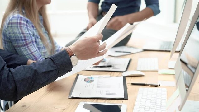 employees discussing and compiling a financial report. close up.