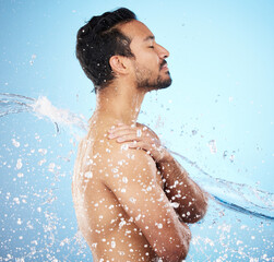 Man, water splash and clean for skincare, wellness and health with beauty, grooming and on blue...