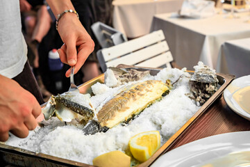 Roasted Branzino or sea bass filleted at a table, Vernazza, Cinque Terre Italy