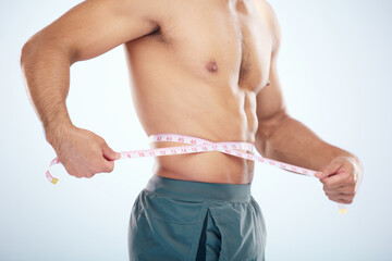 Man, body or measuring tape on waist on studio background for weight loss management, fat control...
