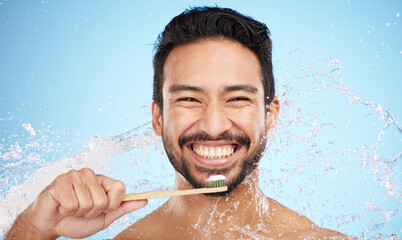 Water splash, portrait or man brushing teeth in studio with toothbrush for white teeth or oral healthcare. Face, tooth paste or happy person cleaning or washing mouth with a healthy dental smile - obrazy, fototapety, plakaty