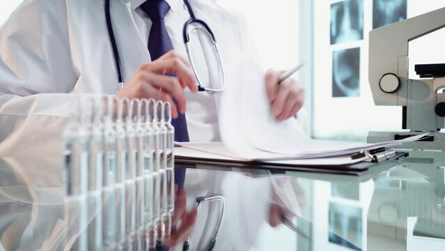 scientist reading documents with the results of the research.