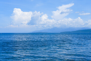 Fototapeta premium sunny day at Bangsring Beach Banyuwangi, floating house in the ocean, blue sky and sea, sea and sky, boat in the sea, beach and sea
