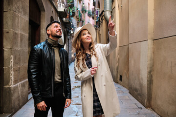 Couple of stylish tourists visiting a city