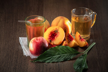 Still life of fresh peaches and apples on a dark background.