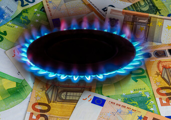 europe flag and hob burner of blue gas with euro cash banknotes on background, cost of gas, the...