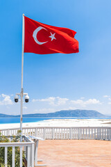 Turkish flag waving in Salda lake. Turquoise waters and blue sky of Salda Lake. Salda Lake is a turquoise crater lake.
Burdur, Turkey