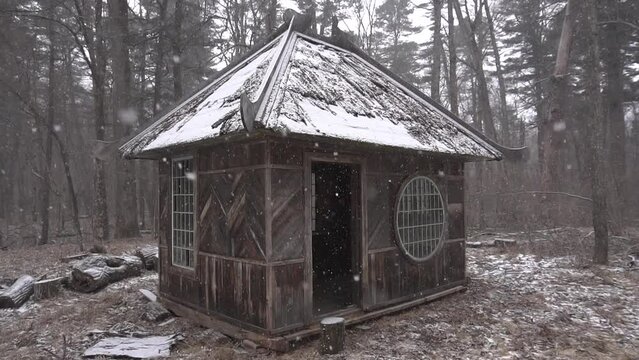 Slow motion. A wooden small house stands during a snowfall in the Far Eastern taiga. Forester's hut.