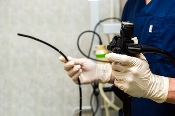 Endoscope in the hands of doctor. Medical instruments used in gastroscopy.Gastric probe