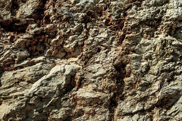 Grungy cragged bumpy pitted cavity stone facade, split layer gap.Ruined cracked worn rough canyon for up raise. Old ragged grunge of steep marble cliff. Grand vintage clefted damaged impressive upland