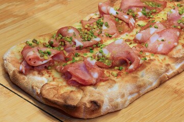 focaccia called PINSA in Italian with Mortadella Sausage and green pistachio grains
