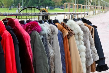 vintage used and new clothes for sale in the stall stand at the flea market