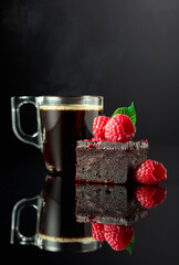 Chocolate cake with fresh raspberries and black coffee.
