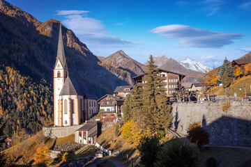 Incredible scenery of European Alps in sunny morning. Heiligenblut church in Austria with...