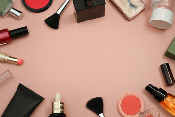 Flat lay composition with different cosmetic products on pink pastel background with copy space for...