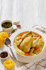 chicken noodle soup of whole chicken in bowl