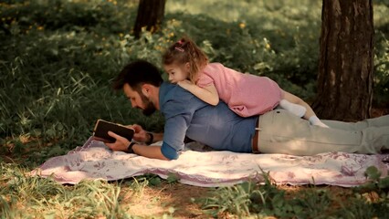 father and his preschool daughter spend time together in park .