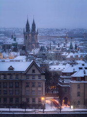 View of Prague roofs and the Tyn temple on the Old town Square in winter. Snow. Prague. Christmas.
