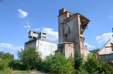 Collapsed industrial multistorey building in daytime. Disaster scene full of debris, broken bricks...