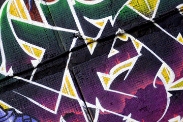 Colorful background of graffiti painting artwork with bright aerosol strips on metal wall. Old...