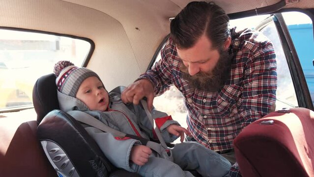 the father is playing with the boy in the constructor. father plays with his son in the constructor