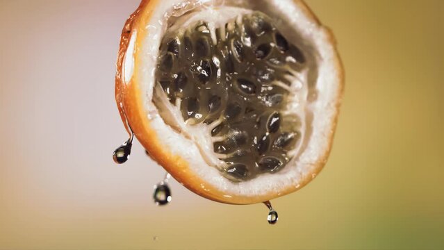 Slow Motion Macro Shot of Flowing Granadilla Juice from Halved Granadilla