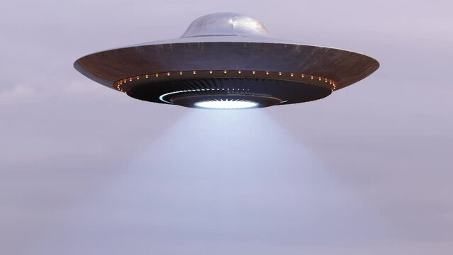 Flying Saucer UFO spaceship with ray isolated on green screen for chroma key, Looped footage in Ultra HD 4K with mask for Stencil Luma masking.