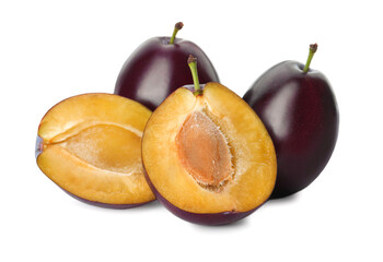 Whole and cut ripe plums on white background