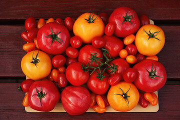 Many fresh tomatoes on wooden surface, top view