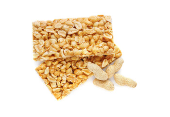 Tasty kozinaki bars and peanuts isolated on white, top view