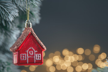 Christmas tree toy in the form of a red house on the Christmas tree