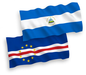 National vector fabric wave flags of Nicaragua and Republic of Cabo Verde isolated on white background. 1 to 2 proportion.