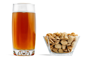 Beer and almonds on white background.