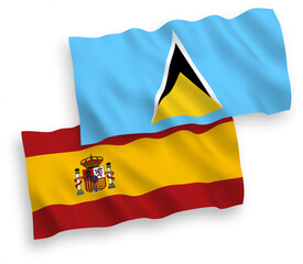 National vector fabric wave flags of Saint Lucia and Spain isolated on white background. 1 to 2 proportion.