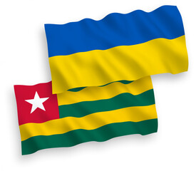 National vector fabric wave flags of Togolese Republic and Ukraine isolated on white background. 1 to 2 proportion.