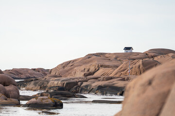 Old lighthouse built 1890 on a granite cliff in Lysekil on the Swedish west coast. Selective focus.