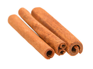 cinnamon sticks in a row lie on a white background