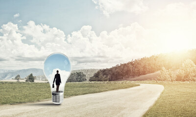 Businesswoman inside light bulb