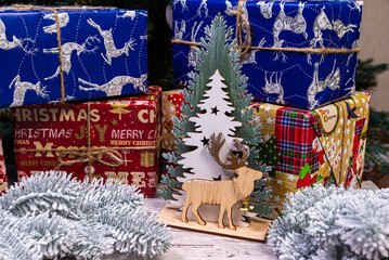 Christmas composition with beautiful decoration, christmas tree and wreath, deer, gifts and accessories in modern home decor.