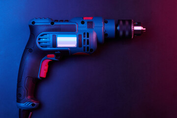 New drill closeup isolated on black background, power tools concept