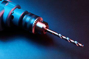 New drill closeup isolated on black background, power tools concept