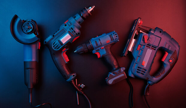 Set of new power tools isolated on a black background, drill, puncher, electric saw, jigsaw, circular saw