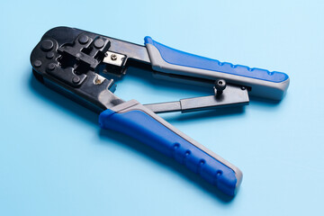 Cable stripping and crimping tool, Wire strippers isolated on blue background